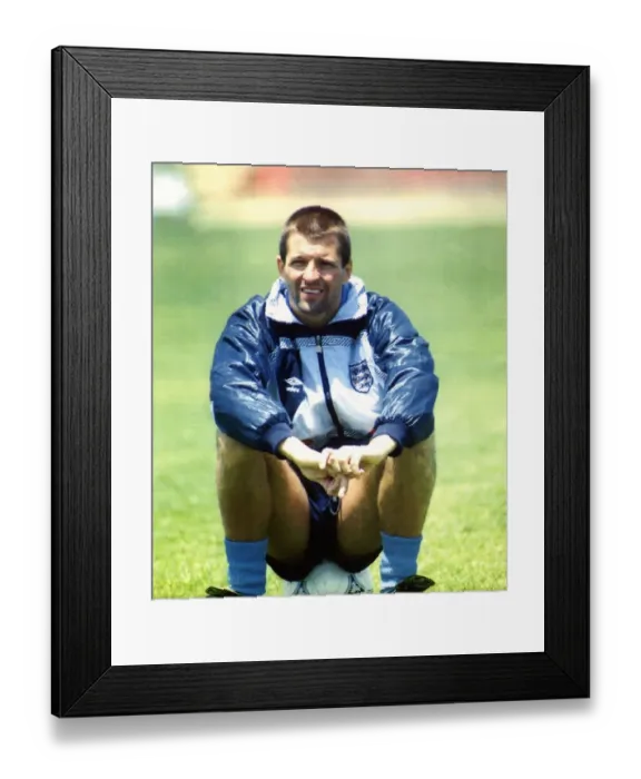 Framed Print : England footballer Steve Bull sitting on a football as he takes a break from training Framed Print : England footballer Steve Bull sitting on a football as he takes a break from training