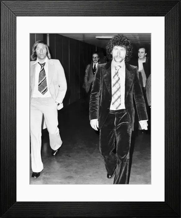 : West German footballer Paul Breitner on his way through Heathrow Airport with fellow : West German footballer Paul Breitner on his way through Heathrow Airport with fellow
