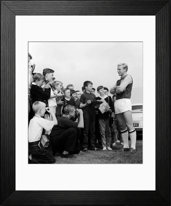 Framed Print : England player Bobby Moore poses for young fans during West Ham United Training