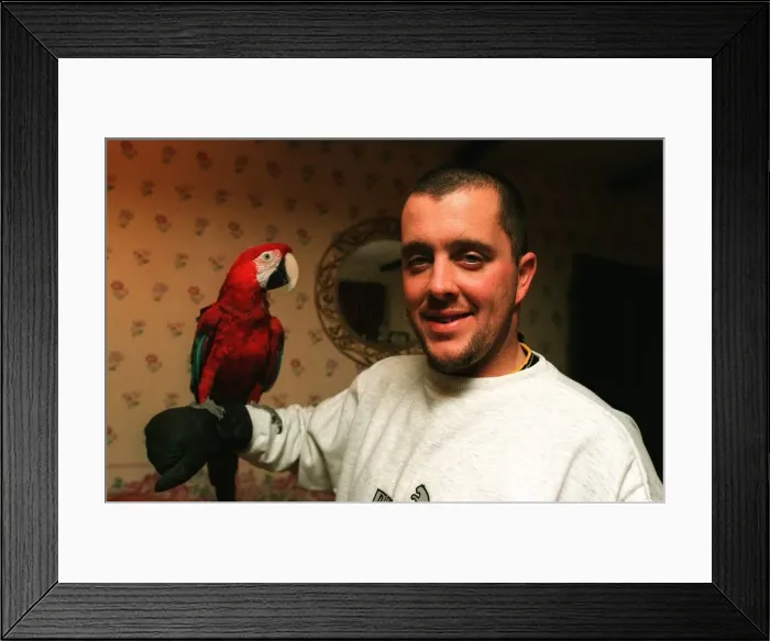 Framed Print : West Ham football player Julian Dicks at home with his pet parrot