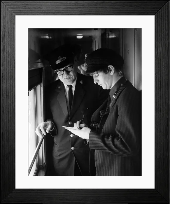 Framed Print : The Beatles February 1964 Drummer Ringo Starr signing an autograph for a train