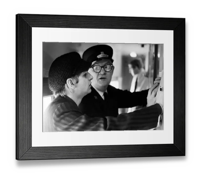 Framed Print : The Beatles February 1964 Ringo Starr with train conductor checking the timetable Framed Print : The Beatles February 1964 Ringo Starr with train conductor checking the timetable
