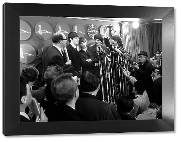 The Beatles answer questions for newsmen and journalists at a press conference upon their