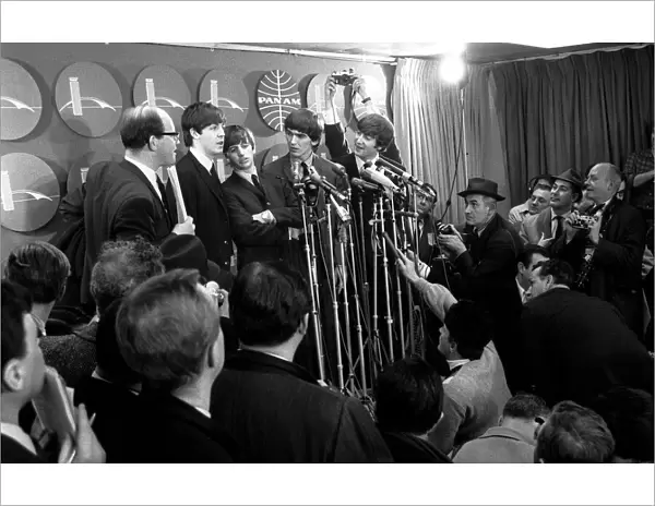 The Beatles answer questions for newsmen and journalists at a press conference upon their
