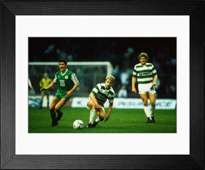 Framed Print : Celtic versus Hibernian Premier League football Chris Morris passes ball upfield Framed Print : Celtic versus Hibernian Premier League football Chris Morris passes ball upfield