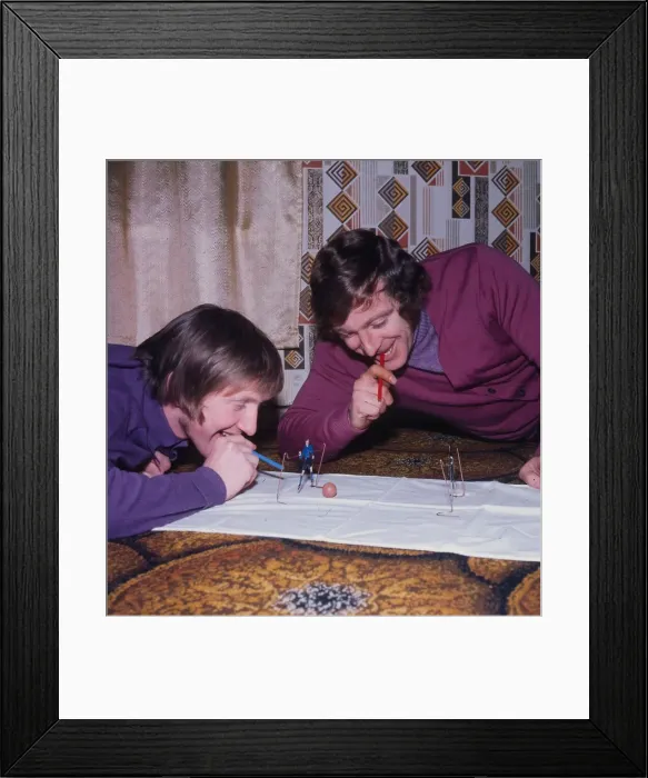 Framed Print : John Brownlie of Hibernian and Dixie Deans of Celtic playing blow football December 1972