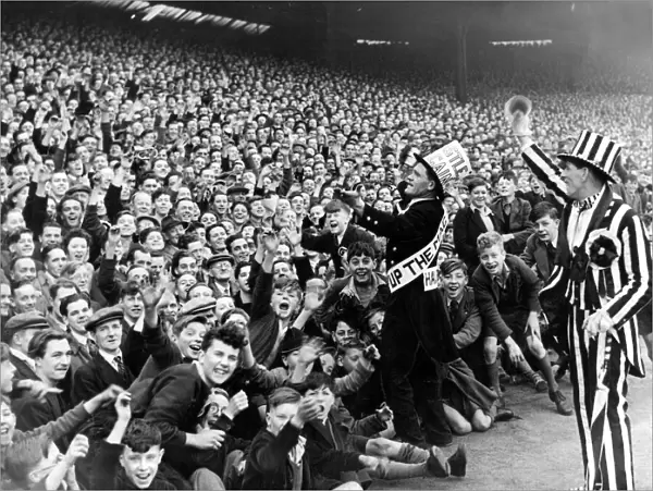 Newcastle mascot Jimmy Nichol leads the cheers of the Newcastle crowd before the game