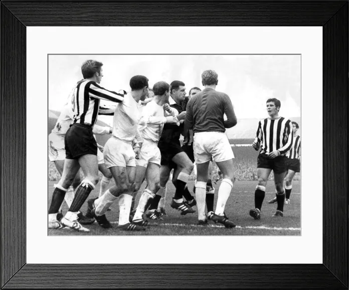 Framed Print : Leeds player Jack Charlton in the middle of this sskirmish in a game against Newcastle