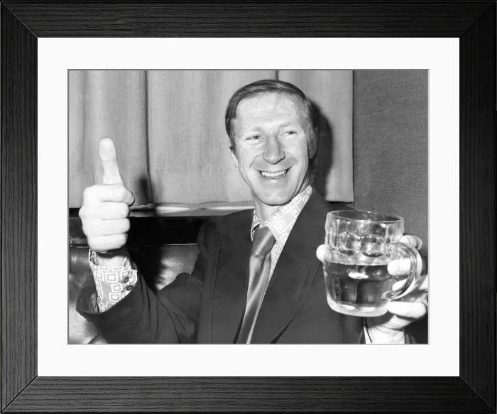 Framed Print : An exuberant Jack Charlton of Leeds United celebrates with a pint