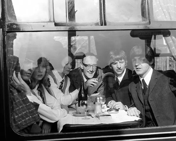 Actor Wilfred Brambell on the train to South Molton, Devon with George Harrison