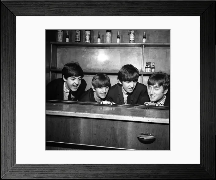 Framed Print : The Beatles in Coventry, amusing themselves with a miniture car race track before Framed Print : The Beatles in Coventry, amusing themselves with a miniture car race track before