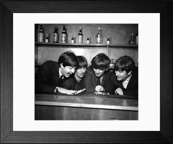 Framed Print : The Beatles in Coventry, amusing themselves with a miniture car race track before