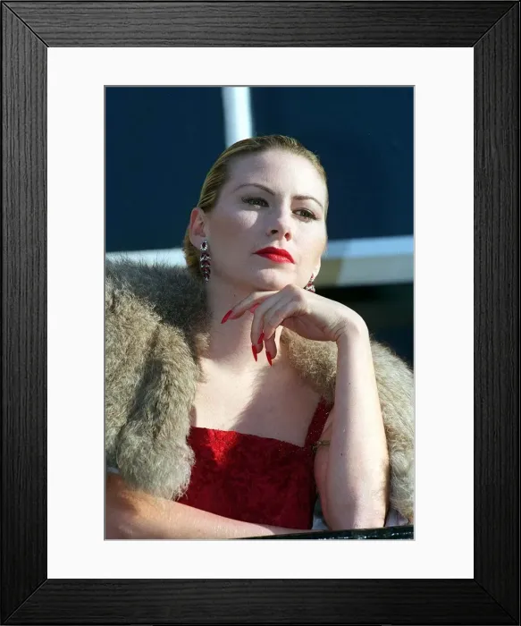 Framed Print : Evita Fashion Model on balcony wearing fur cape red dress long nails with red nail Framed Print : Evita Fashion Model on balcony wearing fur cape red dress long nails with red nail