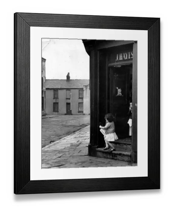 Framed Print : Cardiff - Old - A young child leaves a typical Cardiff corner shop in Butetown Framed Print : Cardiff - Old - A young child leaves a typical Cardiff corner shop in Butetown