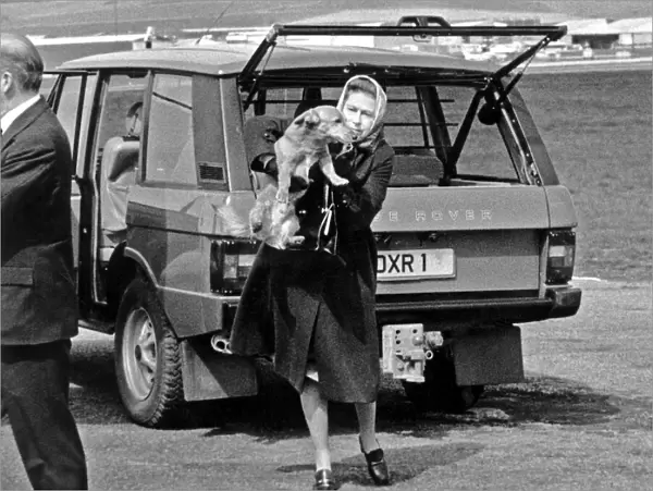 Queen Elizabeth II with one of her corgi dogs. After taking a break in Balmoral