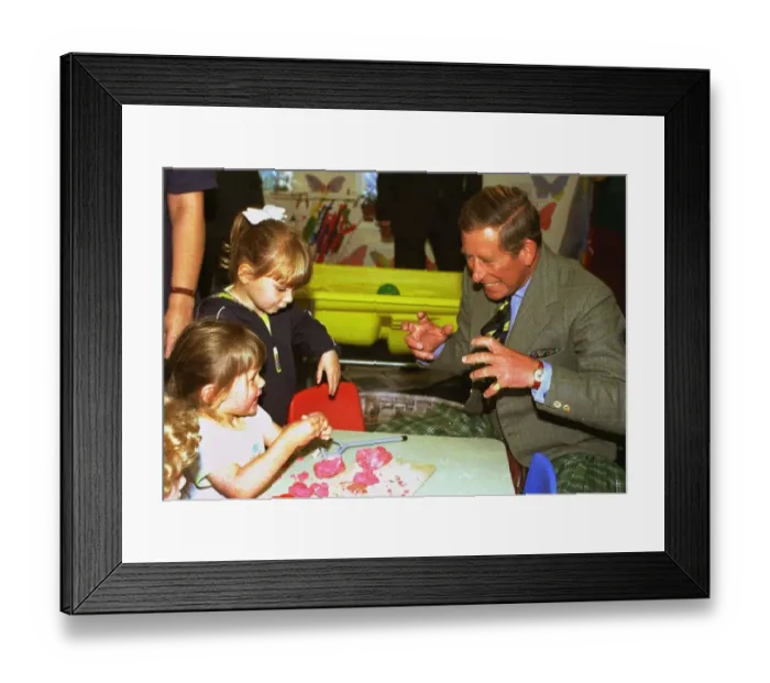 Framed Print : The Prince of Wales jokes with children Lauren Davies, left, aged two