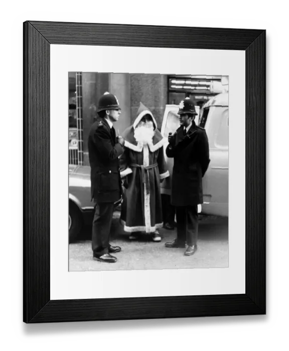 Framed Print : Policemen speak to Santa Claus outside Harrods Store in London after being nicked for