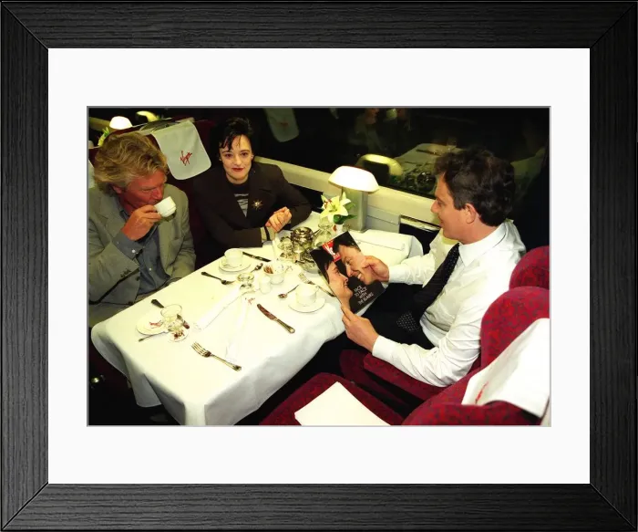 Framed Print : Tony Blair MP reads Yes magazine sitting in dining carriage of train with wife Cherie Framed Print : Tony Blair MP reads Yes magazine sitting in dining carriage of train with wife Cherie