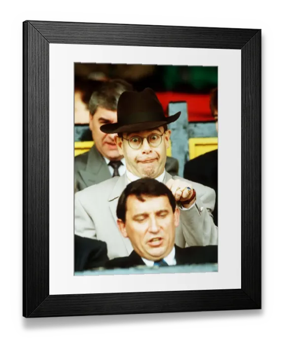 Framed Print : Elton John Singer & Chairman of Watford FC pulls a funny face at Manager Graham Taylor