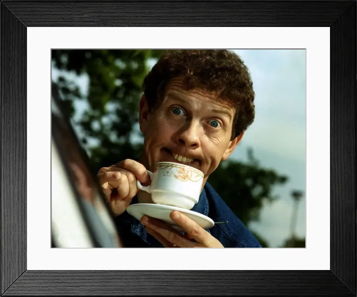 Framed Print : Phil Cool Comic pulling funny face holding cup and saucer Dbase Framed Print : Phil Cool Comic pulling funny face holding cup and saucer Dbase