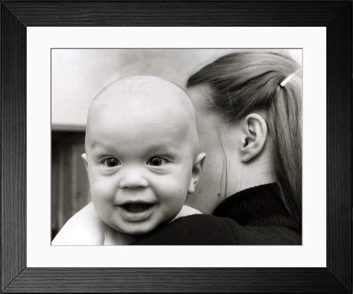 Framed Print : A cute baby looking over shoulder of his mother February 1979 Framed Print : A cute baby looking over shoulder of his mother February 1979