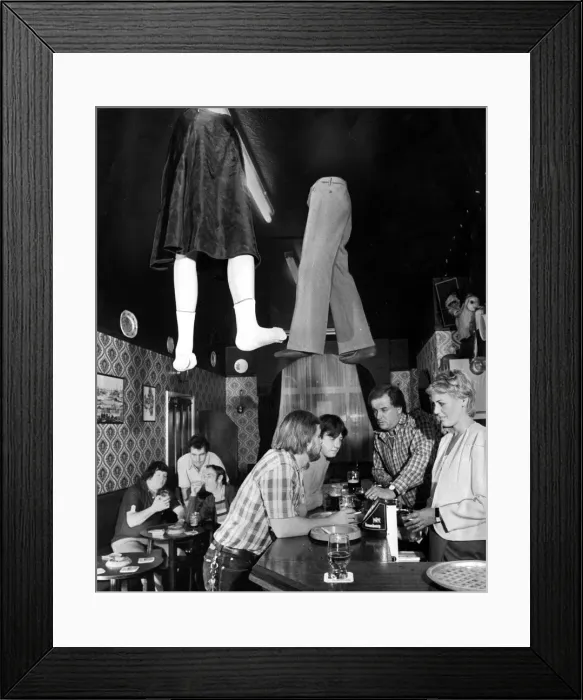 Framed Print : Legs coming through the roof a local pub as customers order more drinks from the bar