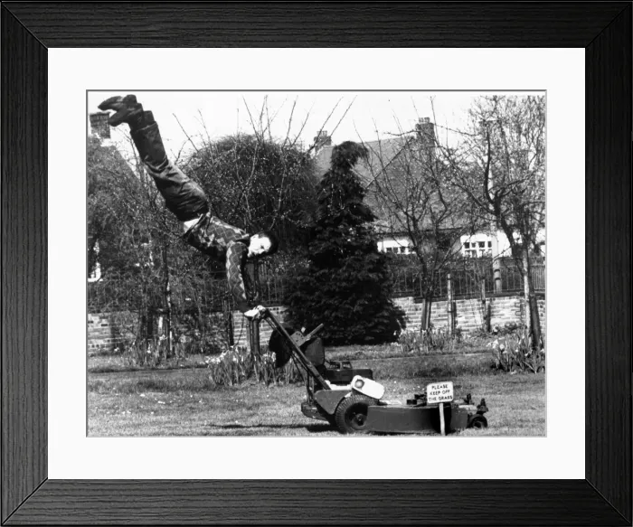 Framed Print : A man mowing his lawn making sure to keep his feet off the grass A© Framed Print : A man mowing his lawn making sure to keep his feet off the grass A©