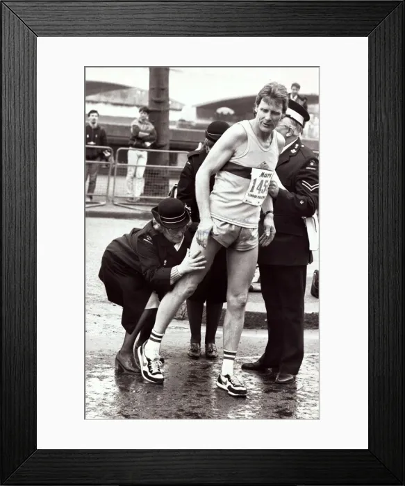 Framed Print : Sport - London Marathon An athlete recieves attention from medics after receiving Framed Print : Sport - London Marathon An athlete recieves attention from medics after receiving