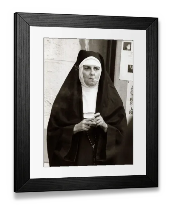 Framed Print : Actress playing the part of a nun takes a cigarette break during filming for A Man Called