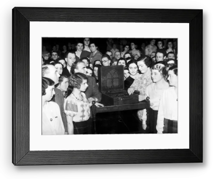 Framed Print : A crowd of people huddle around a wireless to listen to the Abdication Speech of King Framed Print : A crowd of people huddle around a wireless to listen to the Abdication Speech of King