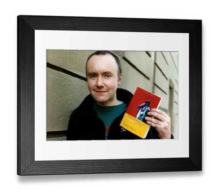 Framed Print : Irvine Welsh author wearing blue fleece jacket green T shirt holding copy of his book Framed Print : Irvine Welsh author wearing blue fleece jacket green T shirt holding copy of his book