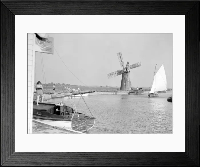 Framed Print : Traditional Norfolk Broad yachts sailing past one of the many windmill water pumps that Framed Print : Traditional Norfolk Broad yachts sailing past one of the many windmill water pumps that