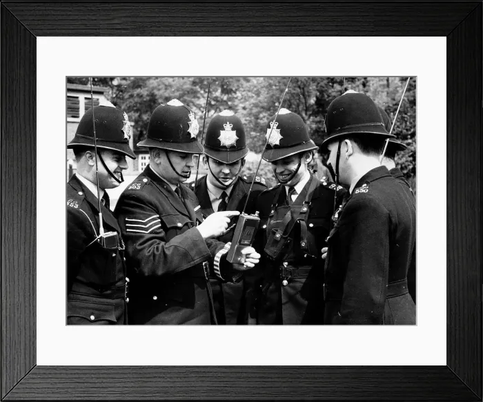 Framed Print : Policemen being shown how to operate their new walkie-talkie radios Framed Print : Policemen being shown how to operate their new walkie-talkie radios