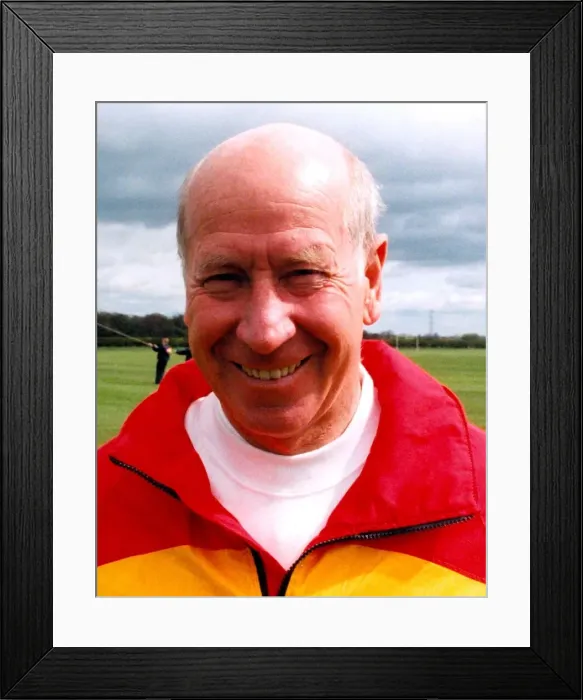 Framed Print : Sir Bobby Charlton gives tips to youngsters on Bullocksteads Sports Ground in May 1996 in