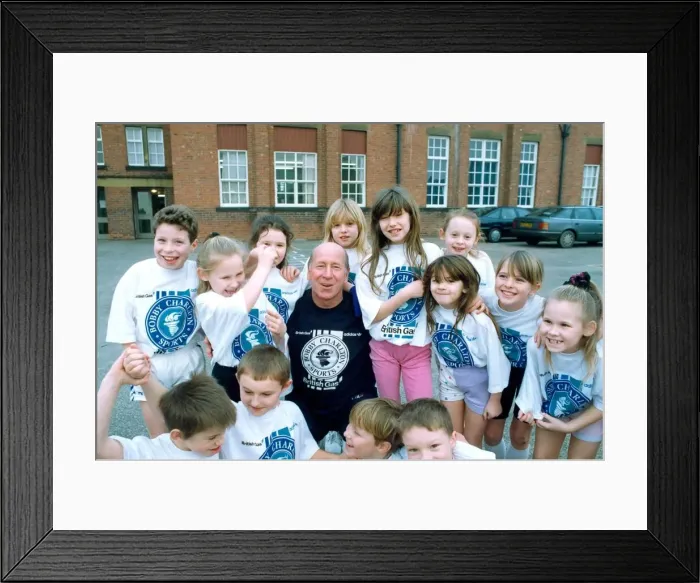 Framed Print : Bobby Charlton with children from Cavendish First School in Ashington in January 1992 Framed Print : Bobby Charlton with children from Cavendish First School in Ashington in January 1992