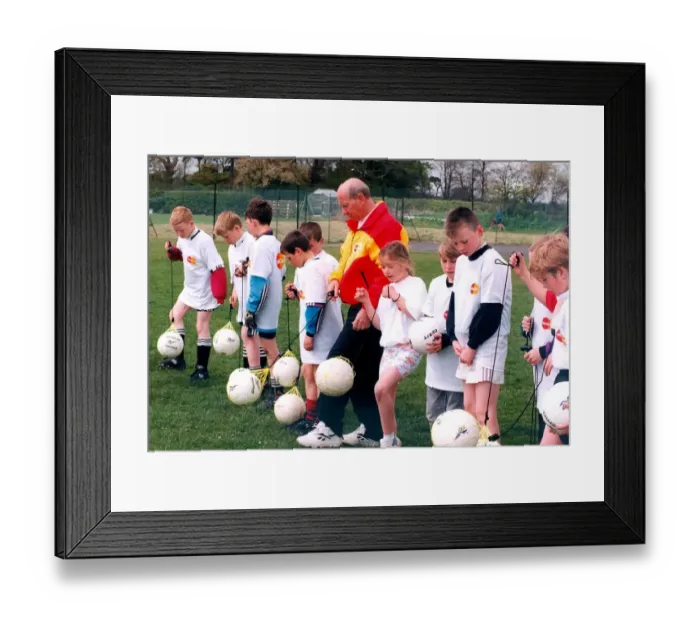 Framed Print : Sir Bobby Charlton gives tips to youngsters on Bullocksteads Sports Ground in May 1996 in Framed Print : Sir Bobby Charlton gives tips to youngsters on Bullocksteads Sports Ground in May 1996 in