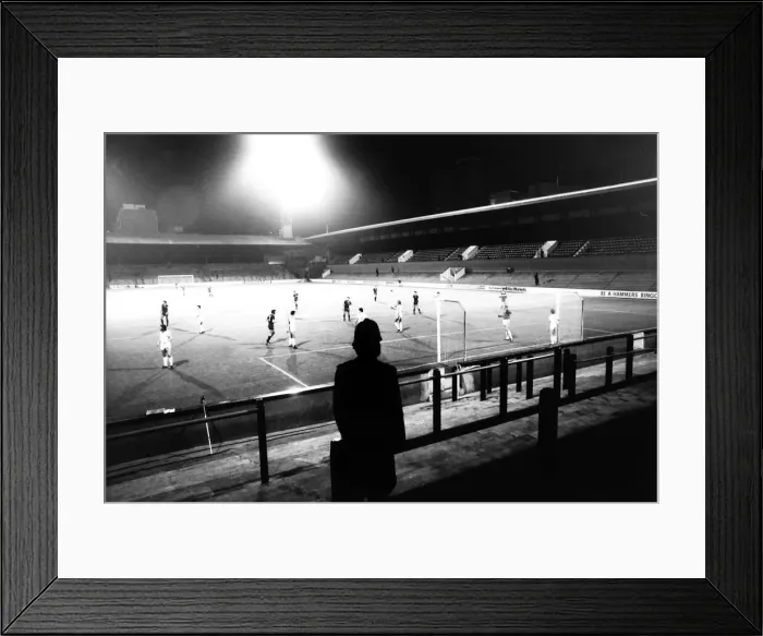 Framed Print : A lone policeman watches from the Upton Park terraces when West Ham played Castilla on a Framed Print : A lone policeman watches from the Upton Park terraces when West Ham played Castilla on a