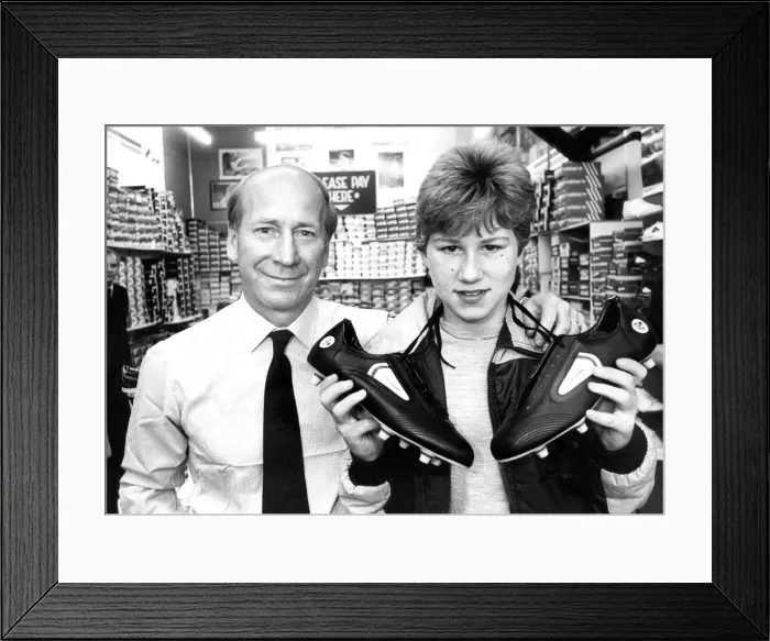 Framed Print : Bobby Charlton with budding soccer star paul Barrett when he chose a pair of football Framed Print : Bobby Charlton with budding soccer star paul Barrett when he chose a pair of football
