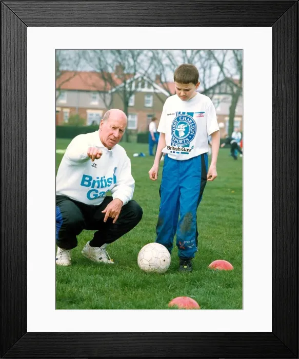 Framed Print : Bobby Charlton gives some advice to youngsters who turned up to see him on is one day Framed Print : Bobby Charlton gives some advice to youngsters who turned up to see him on is one day