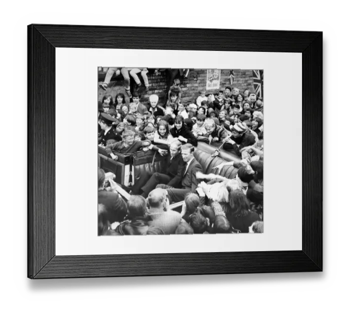 Framed Print : Jack and Bobby Charlton look over-awed as youngsters crowd around the car taking them to