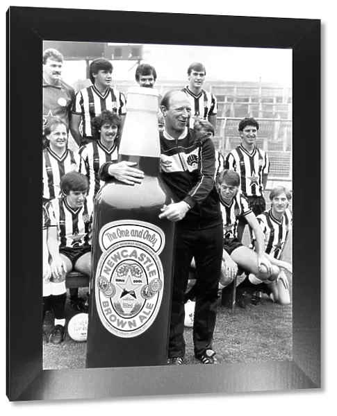 Newcastle United manager Jack Charlton clowning around with a giant Newcastle Brown Ale
