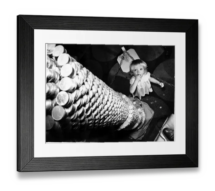 Framed Print : Money A little girl looks up at the tower of 2p coins 9ft high but is reckoned to contain