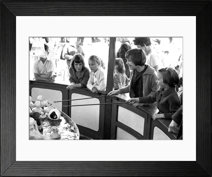 Framed Print : Children enjoying a game of Hook-a-Duck at a stall Framed Print : Children enjoying a game of Hook-a-Duck at a stall