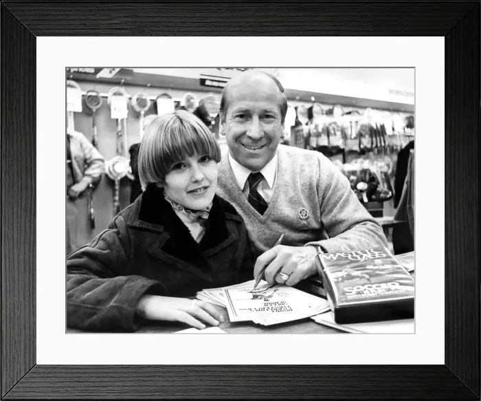 Framed Print : Bobby Charlton signing autographs in Binns, Newcastle in December 1982 Framed Print : Bobby Charlton signing autographs in Binns, Newcastle in December 1982