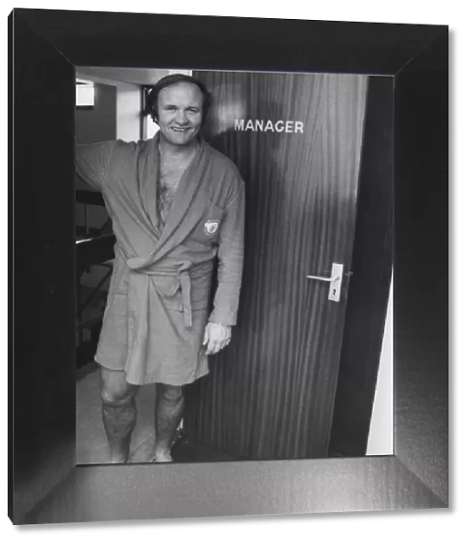 Manchester United manager Ron Atkinson stands at the doorway to the manager
