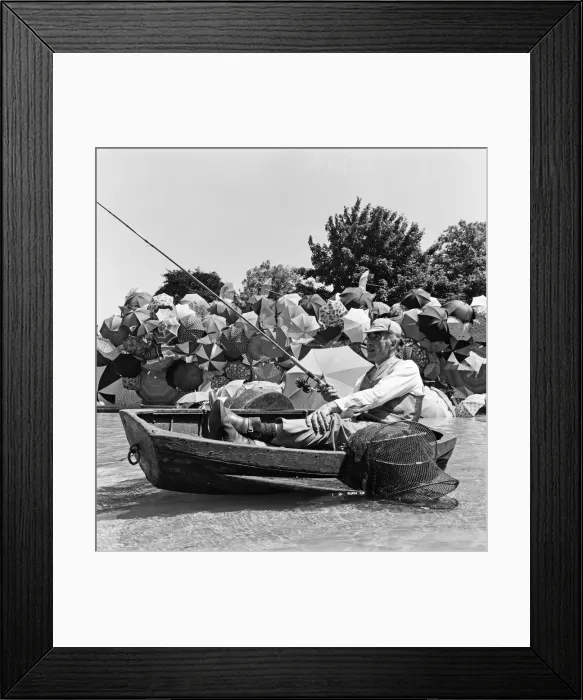 Framed Print : Joe Carver, owner of an umbrella making business, sits in a fishing boat smoking a cigar Framed Print : Joe Carver, owner of an umbrella making business, sits in a fishing boat smoking a cigar