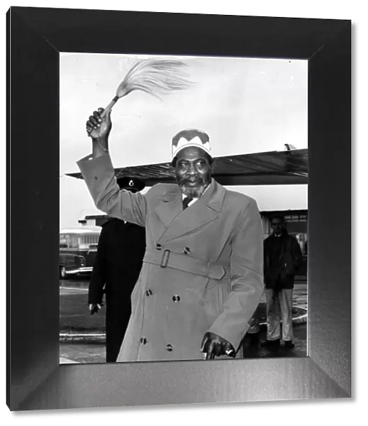 Kenya - Jomo Kenyatta waves his symbol of office - his fly-whisk - on his arrival at