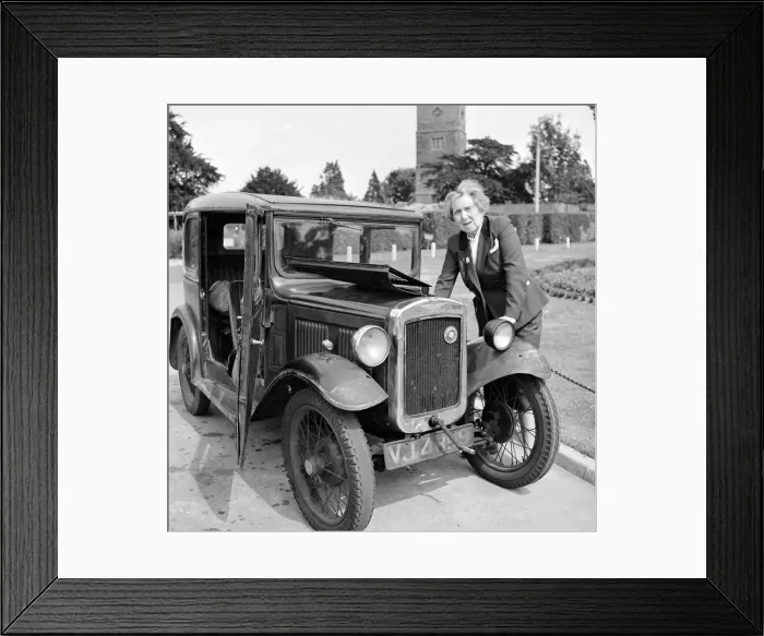 Framed Print : Mrs Goul looks under the bonnet of her car following a breakdown on the village green Framed Print : Mrs Goul looks under the bonnet of her car following a breakdown on the village green
