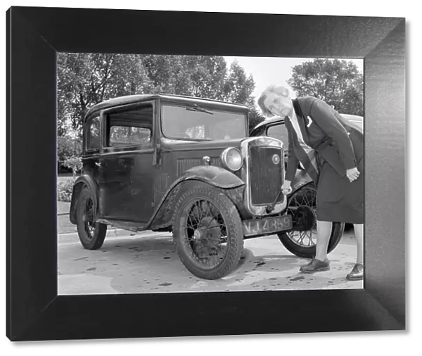 Mrs Goul tries to start her car with the starting handle Circa 1957