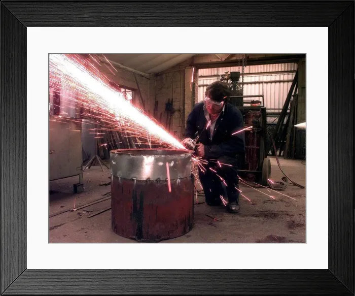 Framed Print : Sparks fly as the blacksmith works at the Forge, in Little Aston, Staffordshire